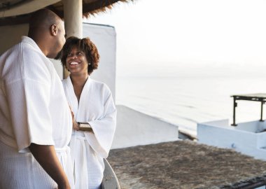 African American couple in bathrobes at hotel clipart