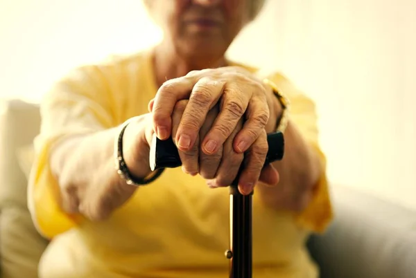 Senior Woman Holding Walking Stick — Stock Photo, Image