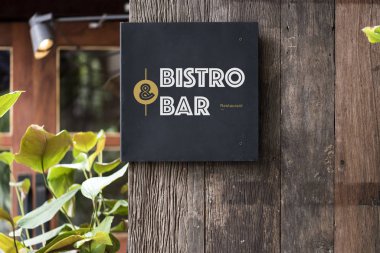 Rustik ahşap duvar mockup üzerinde siyah tabela