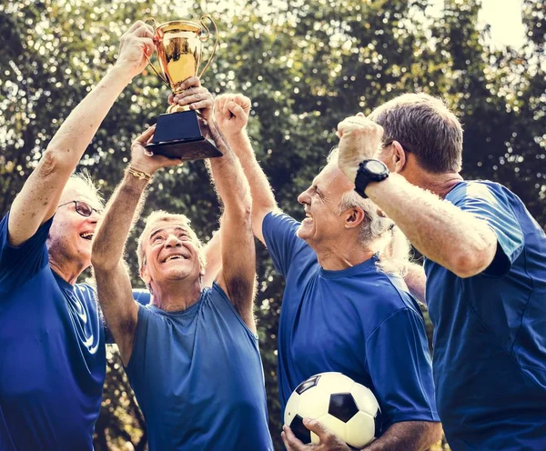 Team Mature Football Players Winning Cup — Stock Photo, Image
