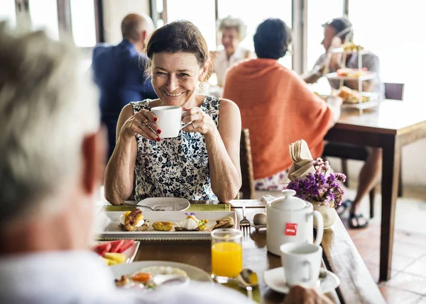 selective focus of smiling woman having breakfast with husband at hotel