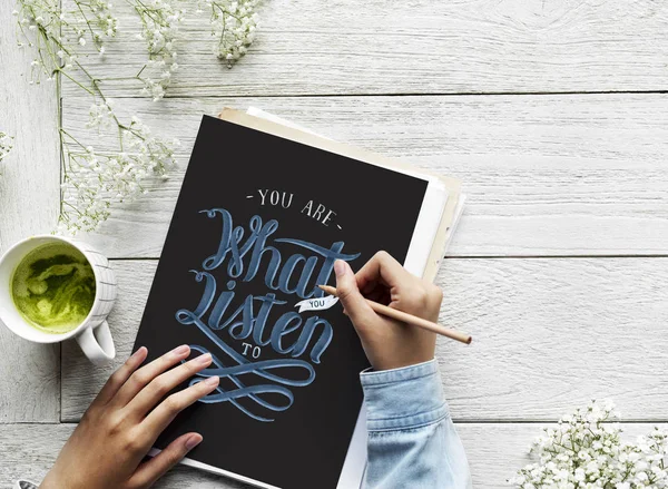 An artist creating hand lettering artwork from motivation quote