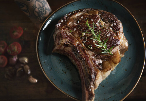 Tomahawk на тарелке с гарниром идея пищевой фотографии рецепт
