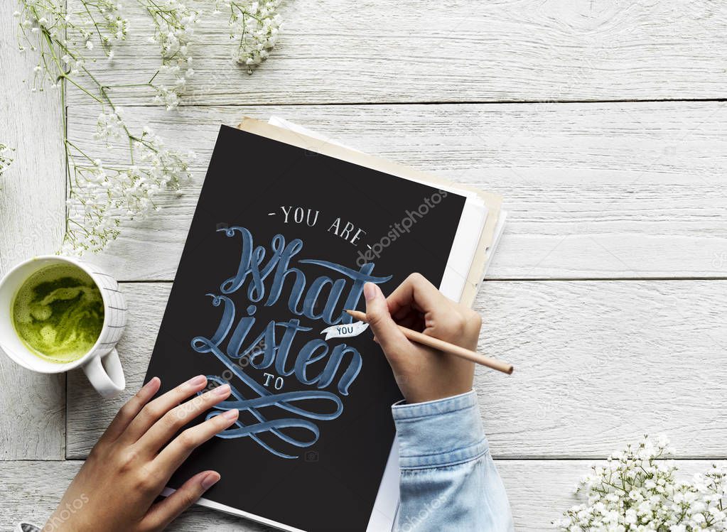 An artist creating hand lettering artwork from motivation quote