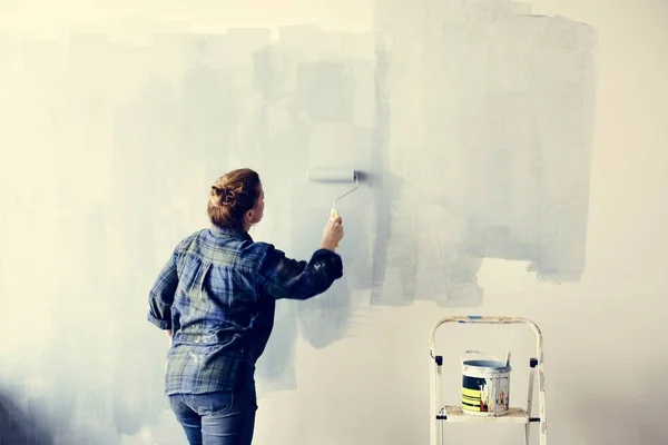 Mulher de construção pintando a parede — Fotografia de Stock