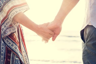 Olgun çift sahilde elele