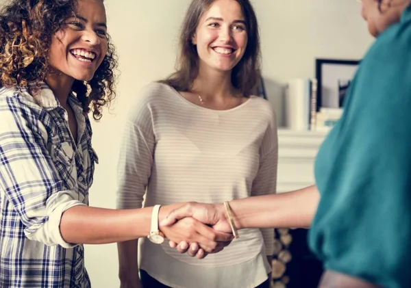 Diverse woman shaking hands