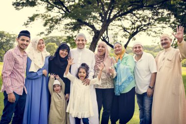 Muslim family having a good time outdoors clipart