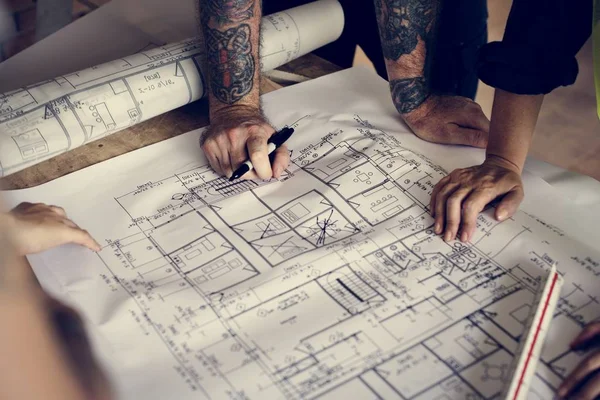 Architect working on a blueprint for a new project — Stock Photo, Image