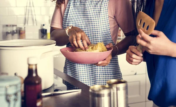 Diverse women cooking in the kitchen together