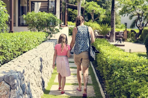 Anne ve kızı el ele tutuşuyorlar.