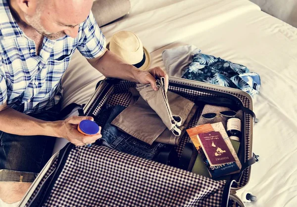 Man packing for a holiday