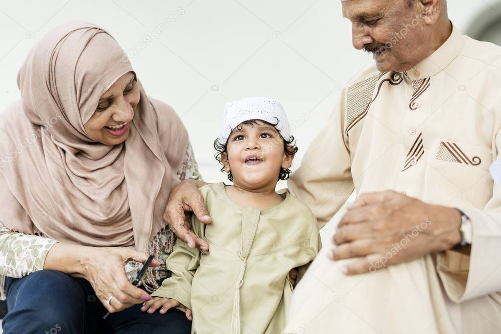 Muslim grandparents with their grandchild