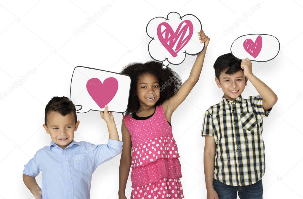 Happy kids holding speech bubbles with heart icons