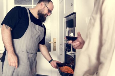 Çiğ somon steak fırına koyarak adam