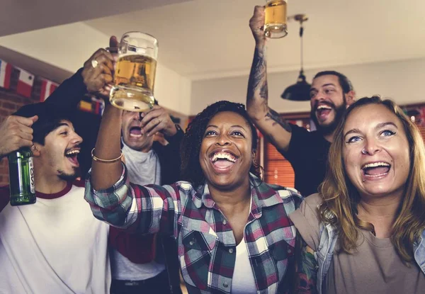 Friends cheering sport at bar together