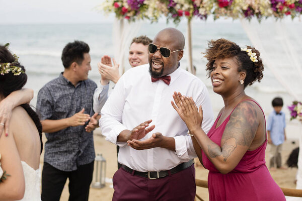 Guests at a beach wedding ceremony