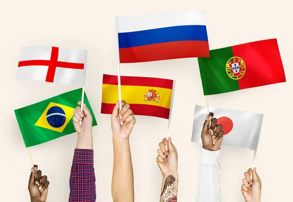 Ręce Wymachując Flagami Anglii Hiszpanii Japonii Portugalii Rosji Brazylii — Zdjęcie stockowe