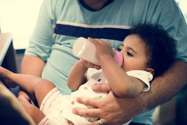 Little girl feeding from formula bottle