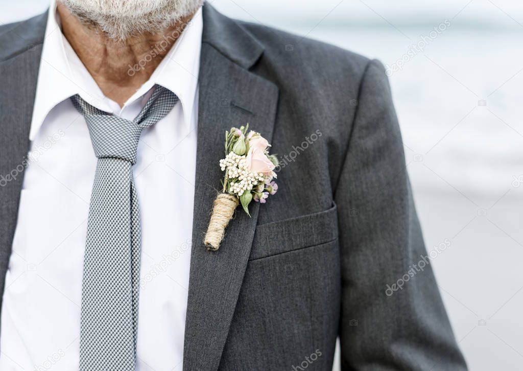Mature groom getting married at the beach