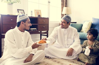 Muslim family having dinner on the floor clipart