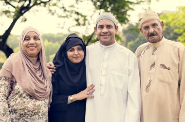 Muslim family having a good time outdoors clipart