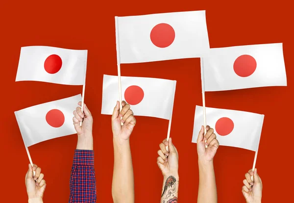 Manos Ondeando Las Banderas Japón —  Fotos de Stock