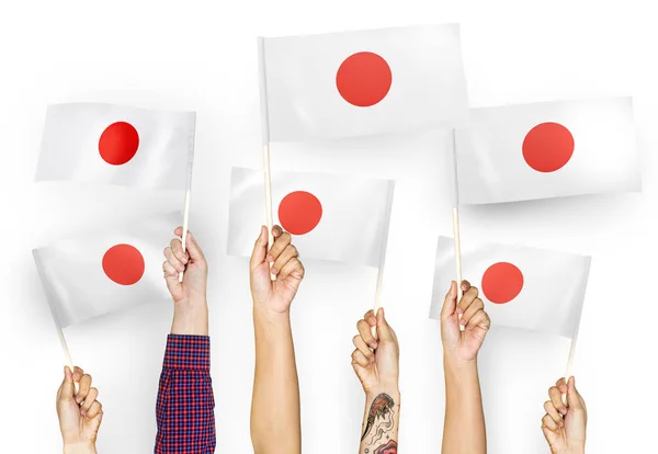 Mãos Agitando Bandeiras Japão — Fotografia de Stock