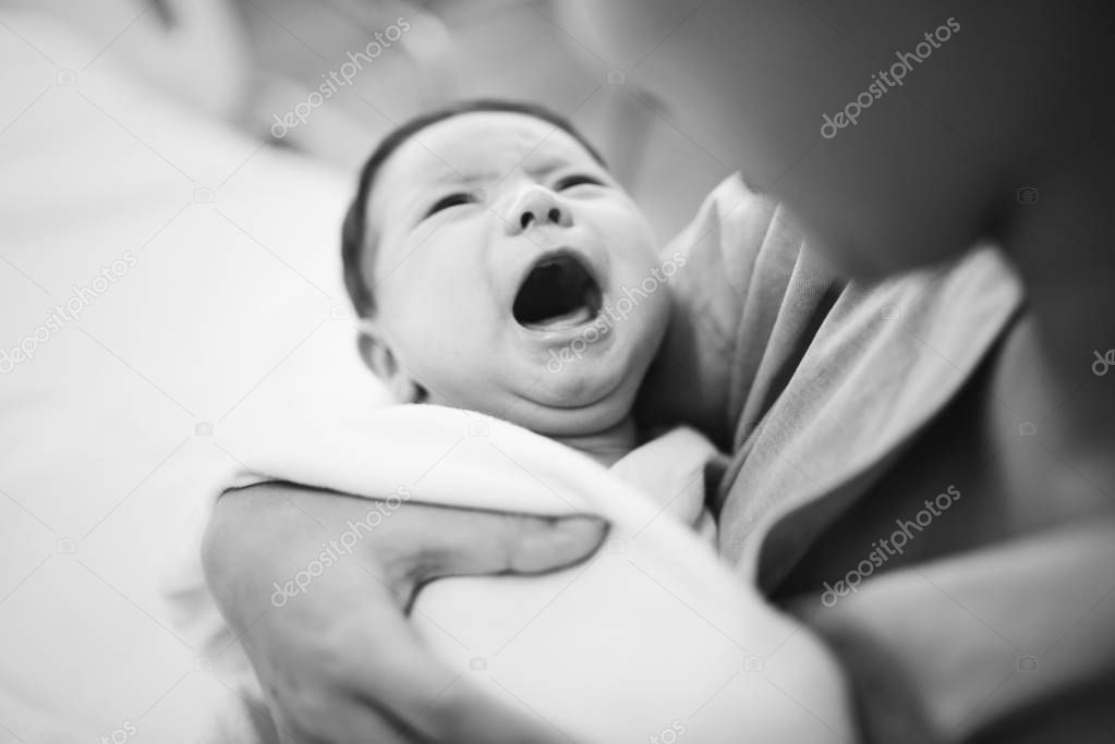 A newborn baby screaming out loud