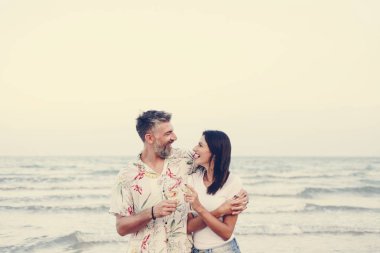 Kumsalda şarap içen çift.