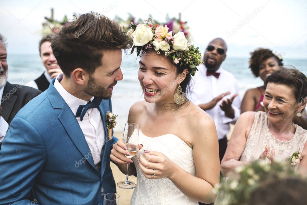 Young Caucasian couple having fun during wedding ceremony at beach