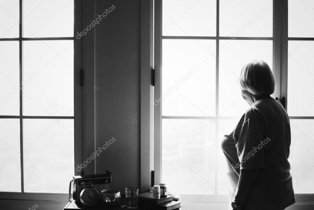 Senior woman standing alone at home