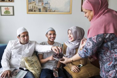 Muslim family having dried dates as a snack clipart