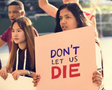 Group of teenagers protesting holding posters saying don't let us die antiwar justice peace concept clipart