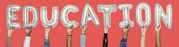 Hands showing education balloons word