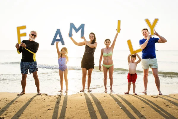 Большая Счастливая Семья Держащая Слово Семья Пляже Перед Закатным Небом — стоковое фото