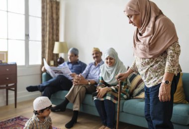 Muslim family relaxing in the home clipart