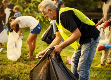 Volunteers picking trash at a park clipart