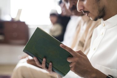 Muslims reading from the quran clipart