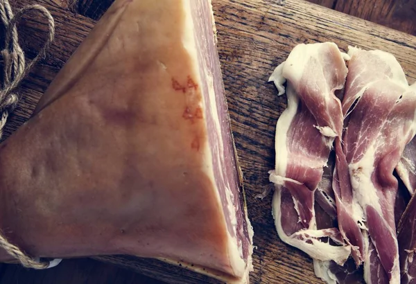 Dry-cured ham at wooden table — Stock Image Dry Cured Ham Wooden Table Stock Photo