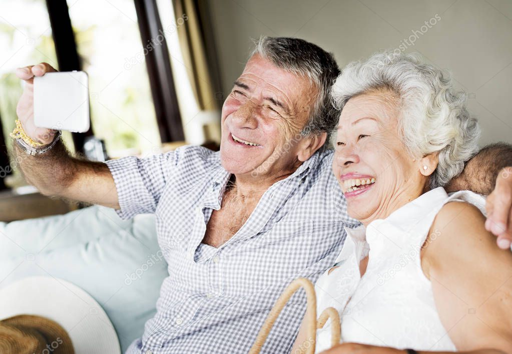 A senior couple taking a selfie