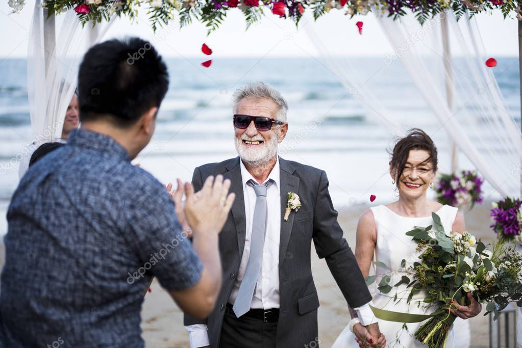 beautiful senior couple getting married at beach