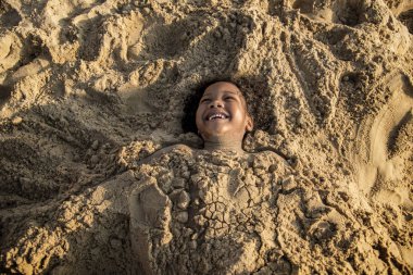 Kumsalda oynarken Afrikalı küçük çocuk