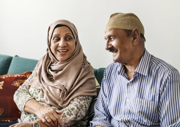 Happy Middle Eastern mature couple at home