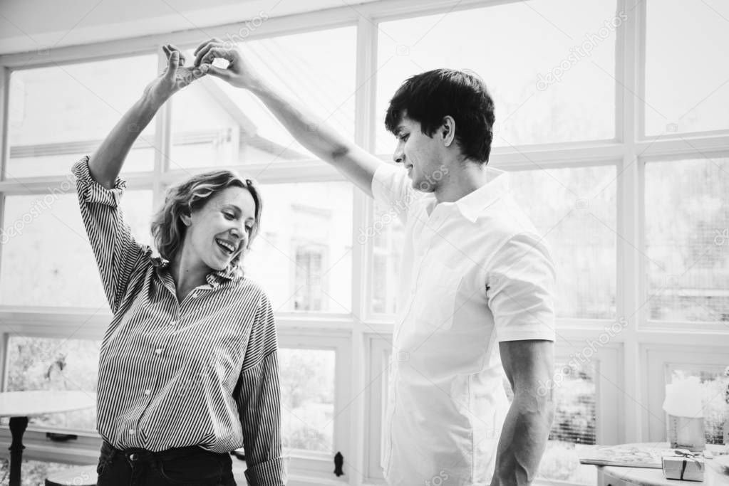 Cheerful couple enjoy dancing together