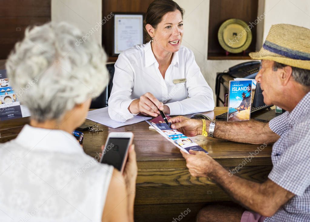Receptionist giving explanations to a senior man