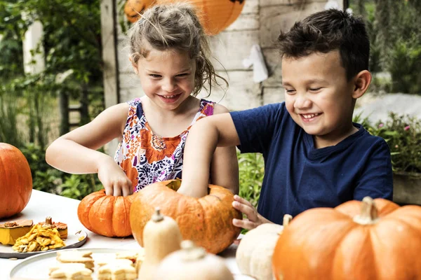 Young Kids Carving Halloween Jack Lanterns — стоковое фото