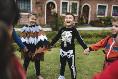 Little kids at a Halloween party clipart