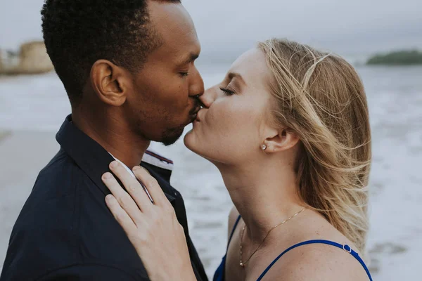 Close up of a sweet couple kissing on the beach