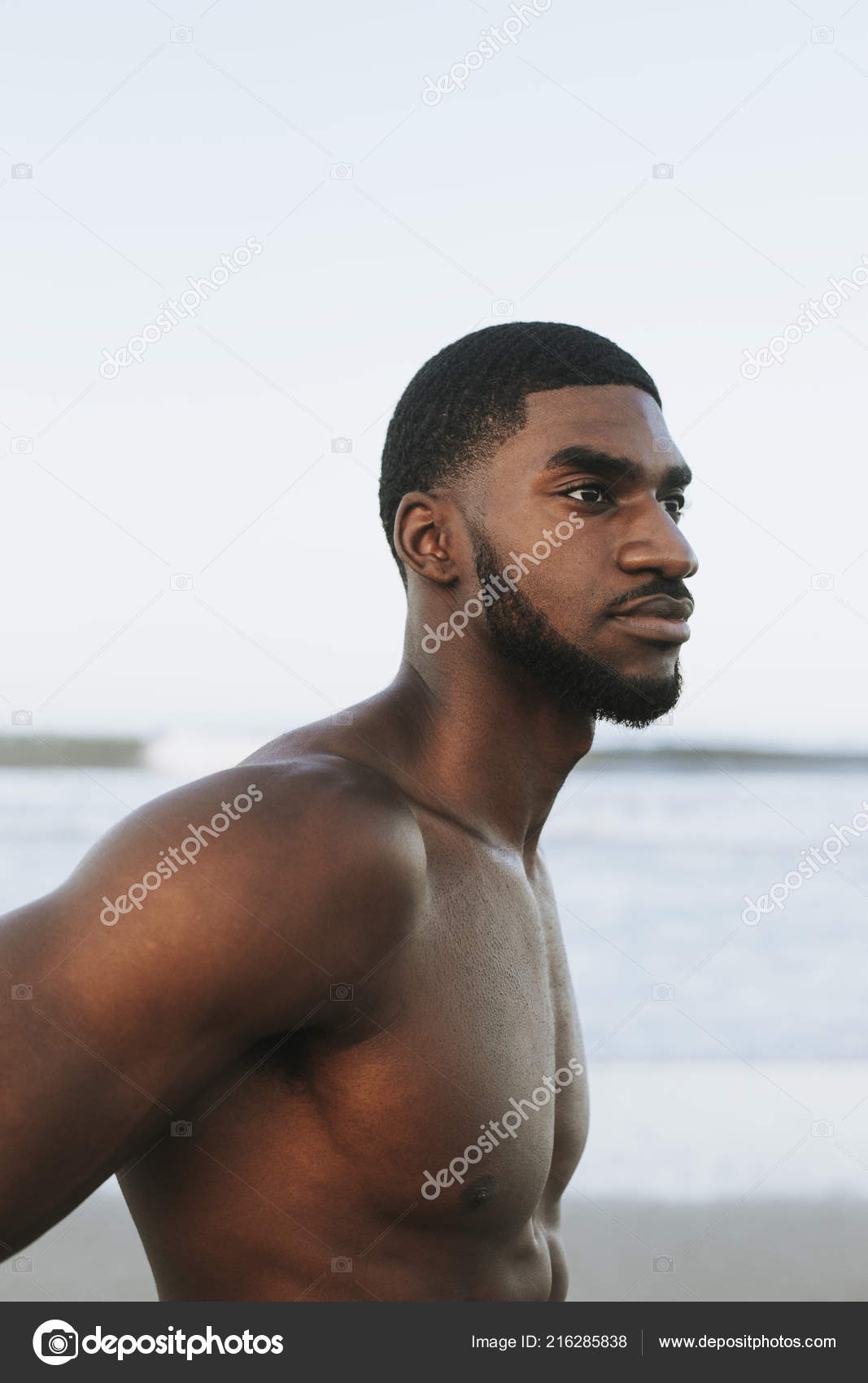 Handsome muscular dark haired surfer athletic muscular and healthy black man  on beach during summer morning warm up ocean india sea Goa vacation Photos  | Adobe Stock